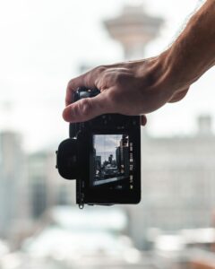 A camera pointed at a tower with the rule-of-thirds grid in the camera monitor.