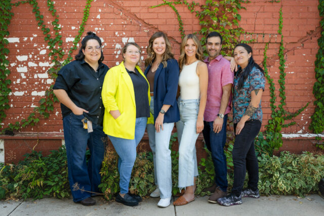 CSU Social Media team, Kayla Coolbear, Teddi Tostanoski, Kimberly Stern, Ashley Schroeder, Arnesh Koul and Hannah Tran smiling and standing in a line. 